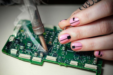 closeup of female hand holding circuit board