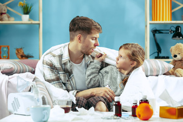 Sick man with daughter at home. Home Treatment. Fighting with a desease. Medical healthcare. Family iIlness. The winter, influenza, health, pain, parenthood, relationship concept. Relaxation at Home