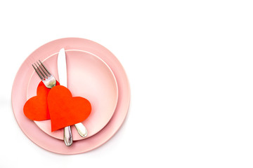 Valentines day (or wedding) set with fork and knife, paper hearts on white background.