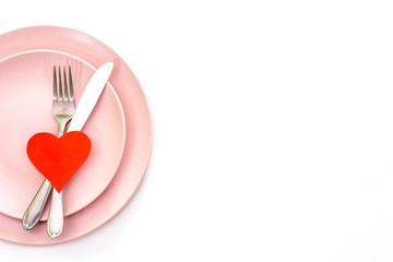 Valentines day (or wedding) set with fork and knife, paper hearts on white background.