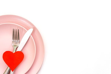 Valentines day (or wedding) set with fork and knife, paper hearts on white background.