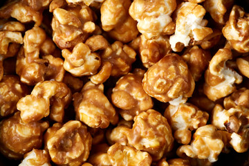 caramel pop corn background. Golden caramel popcorn close up. Background of popcorn. Snacks and food for a movie