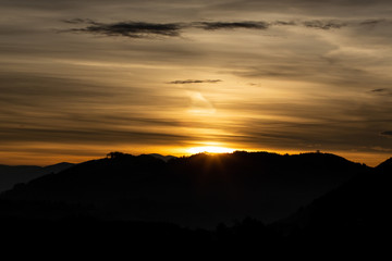 Beautiful romantic sunset in the mountains, black silhouette
