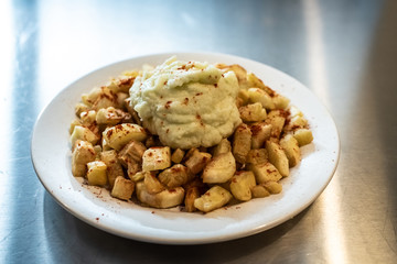 Yuca fried with hummus sauce.