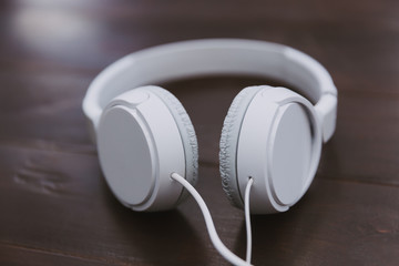 White music headphones on wood table desk
