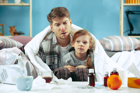 Sick man with daughter at home. Home Treatment. Fighting with a desease. Medical healthcare. Family iIlness. The winter, influenza, health, pain, parenthood, relationship concept. Relaxation at Home