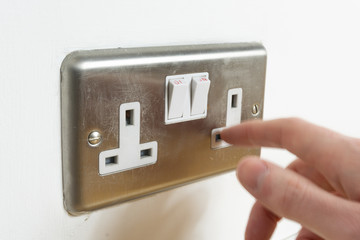 Finger going in electrical plug socket. Safety concept