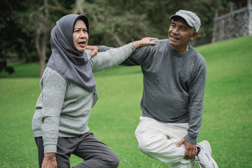 asian muslim senior couple exercising together