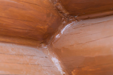 Wooden painted rustic wall of new logs for background