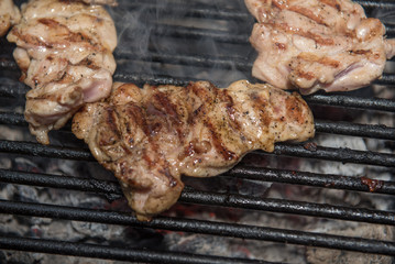 Grilling  steaks on barbecue grill