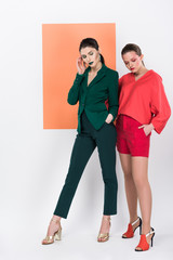 Fototapeta premium beautiful fashionable young women with eyes closed posing with living coral on background