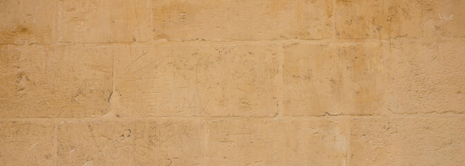Traditional limestone wall facade background in Malta, banner