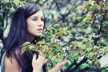 Woman in front of sakura spring blossoms 