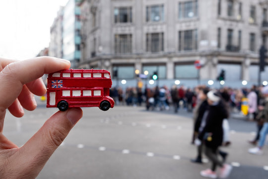 man with a londoner red double-decker bus