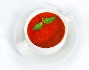 Delicious red tomato soup in bowl on white