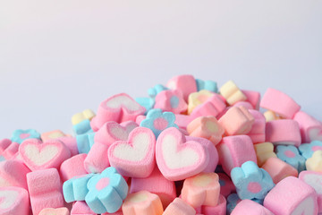 Pair of Pink and White Heart Shaped Marshmallow on the Pile of Pastel Color Flower Shaped...