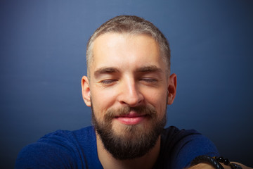 Fototapeta premium Portrait of a young man with a beard. Toned