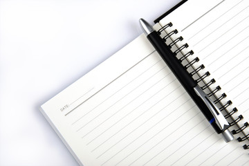 Note pad and ball pen on white background
