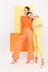 beautiful stylish girls posing with turmeric and limelight on background