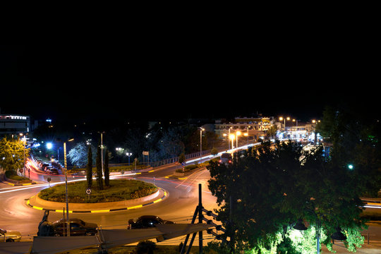 The bridge of the Pinios River and the roundabout in a night photo. Light painting from car lights. In the city of Larissa