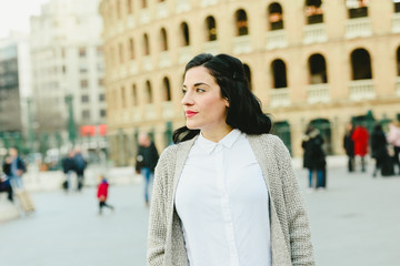 Fototapeta premium Portrait of mature woman waiting outside, side view.