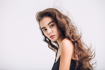 Young beautiful girl model Asian brunette with long hair posing in Studio on isolated background