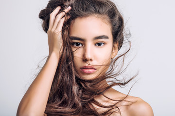 Young beautiful girl model Asian brunette with long hair posing in Studio on isolated background