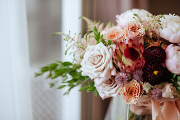 Wedding flowers, bridal bouquet closeup. Decoration made of roses, peonies and decorative plants, close-up, selective focus, nobody, objects