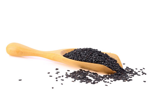 Black Sesame Seeds in wooden scoop isolated on white background