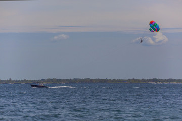couple enjoy parasailing on a sunny vacation day on the tourist destination Mactan Island