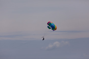 couple enjoy parasailing on a sunny vacation day on the tourist destination Mactan Island