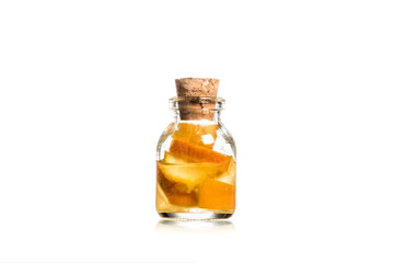 Studio shot of glass jar with fruit pieces isolated on white