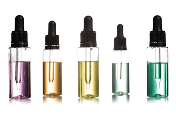 Studio shot of cosmetic serum in bottles with droppers isolated on white