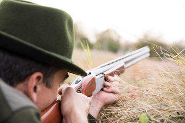 Hunter aiming with his Shotgun