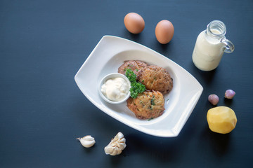 potato pancakes on a white plate. Milk, eggs, farm products.