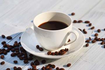 Coffee cup and coffee beans on the table 