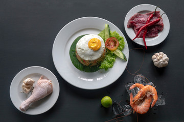 Asian dish fried rice with vegetables, egg and beef or chicken or seafood