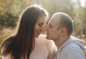 Fototapeta premium Funny couple toghether with a smile. Happy young family in forest.