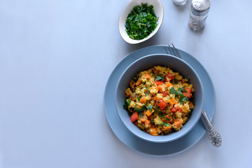Healthy vegan bowl with quinoa, pumpkin, pepper and carrot on gray wooden background. Selective focus