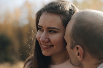 Naklejka premium Funny couple toghether with a smile. Happy young family in forest.