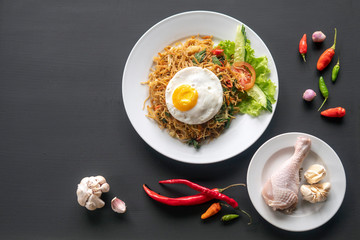 Asian dish fried noodles with egg and seafood or beef or chicken