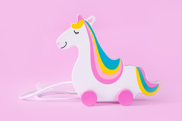 Minimalistic concept - toy unicorn on pink background, copy space