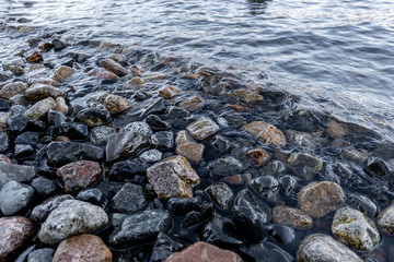 stones on the beach and waves