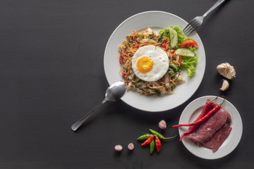 Asian dish fried noodles with egg and seafood or beef or chicken