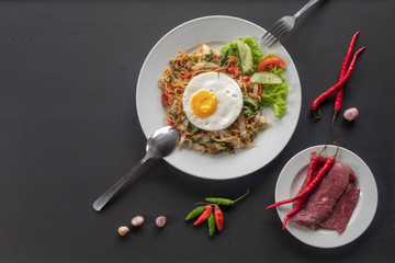 Asian dish fried noodles with egg and seafood or beef or chicken