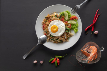 Asian dish fried noodles with egg and seafood or beef or chicken