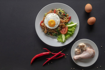 Asian dish fried noodles with egg and seafood or beef or chicken