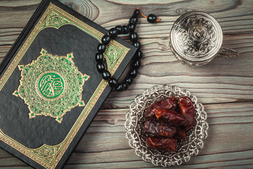 Table top decoration Ramadan Kareem holiday background of dates with  rosary & The holy book of Koran