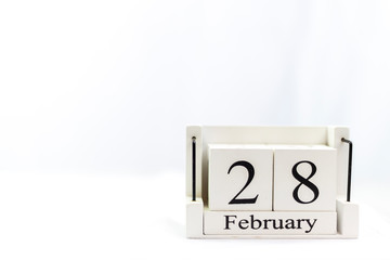 the day of February on a white clear background. a wooden desktop calendar that reminds us of what date we are today.