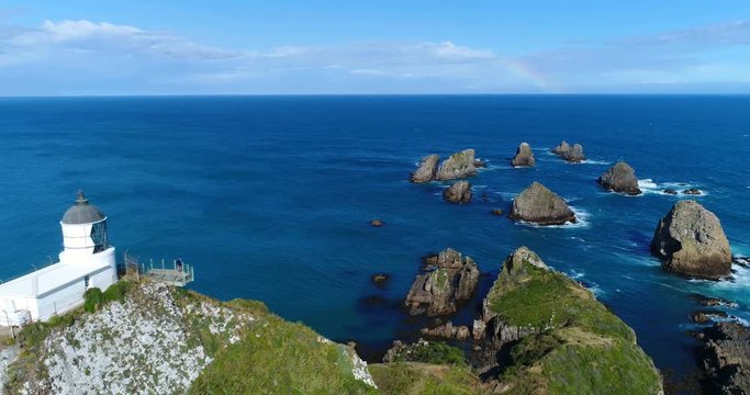 New Zealand aerial drone footage of Nugget Point Lighthouse in Otago region and peninsula on South Island of New Zealand. Beautiful tourist destination and attraction seen from above.